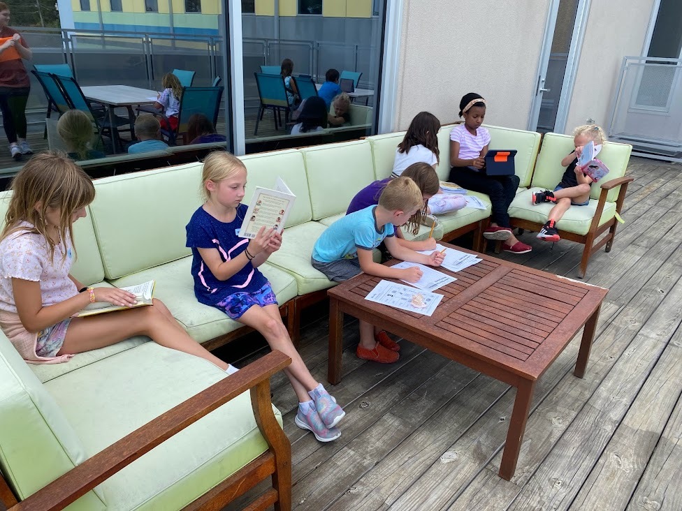 Kids reading and learning outdoors